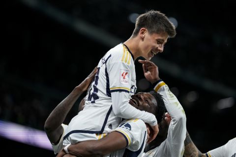 Real Madrid's Arda Guler celebrates with his teammates after scoring his side's fourth goal the Spanish La Liga soccer match between Real Madrid and Celta Vigo at the Santiago Bernabeu stadium in Madrid, Spain, Sunday, March 10, 2024. (AP Photo/Manu Fernandez)