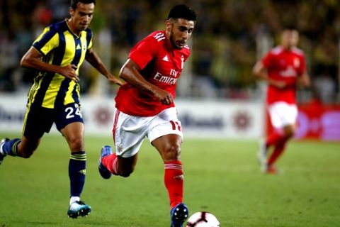 Benfica's Eduardo Salvio runs with the ball chased by Fenerbahce's Baris Alici, left, during the Champions League third qualifying round, second leg, soccer match between Fenerbahce and Benfica at the Sukru Saracoglu stadium in Istanbul, Tuesday, Aug. 14, 2018. (AP Photo/Lefteris Pitarakis)