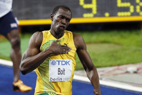 FILE - In this Aug. 16, 2009, file photo, Jamaica's Usain Bolt celebrates setting a new men's 100-meter world record at the World Athletics Championships in Berlin. Karsten Warholm's staggering run to shatter his own 400-meter hurdles world record at the Olympics on Tuesday, Aug. 3, 2021, has posed the question: Was it the greatest track race ever? Maybe. (AP Photo/Michael Sohn, File)