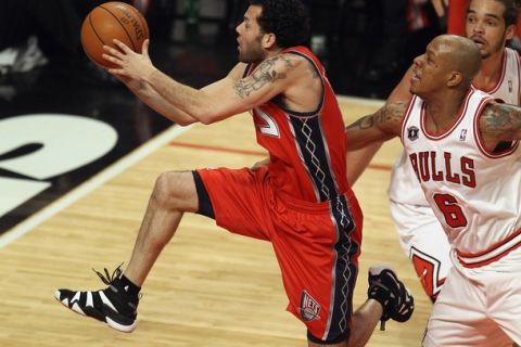 CHICAGO, IL - APRIL 13: Jordan Farmar #2 of the New Jersey Nets drives to the basket past Keith Bogans #6 of the Chicago Bulls at United Center on April 13, 2011 in Chicago, Illinois. NOTE TO USER: User expressly acknowledges and agress that, by downloading and/or using this photograph, User is consenting to the terms and conditions of the Getty Images License Agreement. (Photo by Jonathan Daniel/Getty Images)