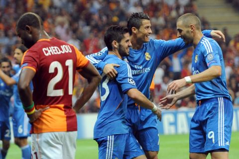 Real Madrid's Karim Benzema (R) is congratulated by teammates after scoring during the UEFA Champions League football match Galatasaray vs Real Madrid on September 17, 2013 at the TT Arena Stadium in Istanbul.     AFP PHOTO/ MIRAMIRA/AFP/Getty Images