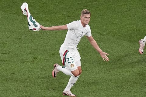 Hungary's Kevin Csoboth (23) celebrates his goal with Dominik Szoboszlai (10) and Roland Sallai (20) during a Group A match between Scotland and Hungary at the Euro 2024 soccer tournament in Stuttgart, Germany, Sunday, June 23, 2024. (AP Photo/Ariel Schalit)