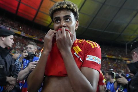 Spain's Lamine Yamal celebrates after winning the final match between Spain and England at the Euro 2024 soccer tournament in Berlin, Germany, Sunday, July 14, 2024. (AP Photo/Matthias Schrader)