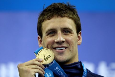 SHANGHAI, CHINA - JULY 31:  Ryan Lochte of the United States poses with his gold medal after the Men's 400m Individual Medley Final during Day Sixteen of the 14th FINA World Championships at the Oriental Sports Center on July 31, 2011 in Shanghai, China.  (Photo by Ezra Shaw/Getty Images)