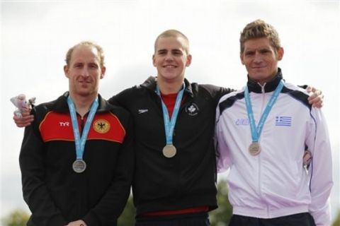 Gold medalist Canada's Richard Weinberger, center, poses with silver medalist Germany's Thomas Lurz, left, and bronze medalist Greece's Spyros Gianniotis during the medal ceremony of the10km marathon swimming International Olympic test event at Hyde Park's Serpentine lake in London, Saturday, Aug. 13, 2011. Hyde Park will host the London 2012 Olympic 10km Marathon Swimming competition next year. (AP Photo/Sang Tan)