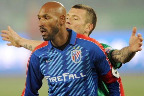 French International player Nicolas Anelka (L) from the Shanghai Shenhua club stands in front of opponent Darko Matic (R) during Shanghai Shenhua's 2-3 league match loss against Beijing Guoan at the Workers Stadium in Beijing on March 16, 2012.  The French striker, the most high-profile foreign footballer ever to sign for the Super League, and has signed a two-year contract worth 270,000 euros (about 350,000 USD) a week for the Chinese Super League side.   AFP PHOTO/Mark RALSTON (Photo credit should read MARK RALSTON/AFP/Getty Images)