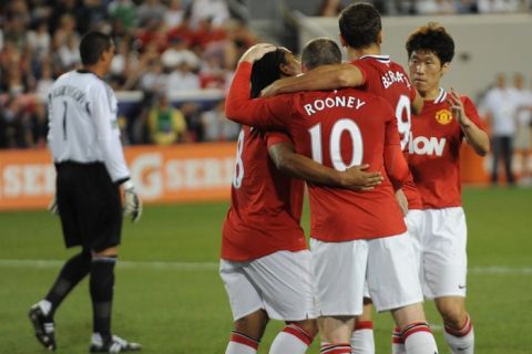 Anderson (L) of Manchester United is congratulated by teammates Wayne Rooney (2L), Dimtar Berbatov (2R) and Ji-Sung Park (R) after Anderson scored a goal in the 20th minute of the first half against the MLS All-Stars on July 27, 2011 at Red Bull Arena in Harrison, NJ. Manchester United won the friendly match 4-0. Too the extreme left is MLS All-Star goalkeeper Faryd Mondragon.  AFP PHOTO / DON EMMERT (Photo credit should read DON EMMERT/AFP/Getty Images)