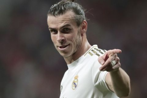 FILE - In this Saturday, Sept. 28, 2019 file photo, Real Madrid's Gareth Bale gestures during the Spanish La Liga soccer match between Atletico Madrid and Real Madrid at the Wanda Metropolitano stadium in Madrid. The immediate future of Gareth Bale is once again in doubt after he travelled to London with permission of Real Madrid to see his agent this week. That reignited speculation about a possible departure after his coach said in July that it would best for player and club to part ways. Zinedine Zidane has since backtracked and said that Bale is an important player for him, but the damage was done to the public image of their relationship. (AP Photo/Bernat Armangue, File)