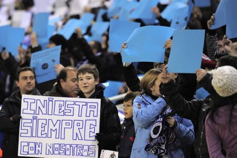 A young Espanyol's fan holds a placard reading "Iniesta always with us" as he greets Barcelona's midfielder Andres Iniesta (unseen) during the Spanish league football match RCD Espanyol vs FC Barcelona on December 18, 2010 at Cornella-El prat stadium in Cornella near to Barcelona.     AFP PHOTO/ JOSEP LAGO (Photo credit should read JOSEP LAGO/AFP/Getty Images)