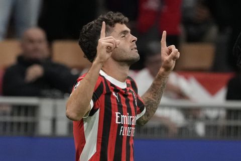 AC Milan's Christian Pulisic celebrates scoring his side's opening goal during the Champions League opening phase soccer match between AC Milan and Liverpool at the San Siro stadium in Milan, Italy, Tuesday, Sept. 17, 2024. (AP Photo/Luca Bruno)