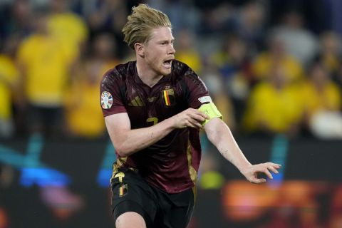 Belgium's Kevin De Bruyne celebrates after scoring his side's second goal during a Group E match between Belgium and Romania at the Euro 2024 soccer tournament in Cologne, Germany, Saturday, June 22, 2024. (AP Photo/Martin Meissner)