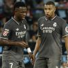 Real Madrid's Kylian Mbappe, right, speaks with Vinicius Junior during a Spanish La Liga soccer match between Celta and Real Madrid at the Balaidos, stadium in Vigo, Spain, Saturday, Oct. 19, 2024. (AP Photo/Lalo R. Villar)