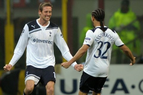 Tottenham's forward Peter Crouch (L) celebrates with team mate defender Benoit Assou-Ekotto after scoring against AC Milan during their Champions League football match on February 15, 2011 at San Siro Stadium in Milan. Tottenham defeated AC Milan 1-0.  AFP PHOTO / GIUSEPPE CACACE (Photo credit should read GIUSEPPE CACACE/AFP/Getty Images)