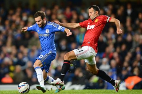 Ryan Giggs of Manchester United in action with Juan Mata of Chelsea.