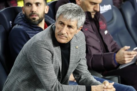 Barcelona's head coach Quique Setien sits on the bench prior of a Spanish Copa del Rey soccer match between Barcelona and Leganes at the Camp Nou stadium in Barcelona, Spain, Thursday, Jan. 30, 2020. (AP Photo/Joan Monfort)