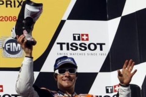 USA's Nicky Hayden holds up one of his race boots to throw into a crowd of fans after he placed third in the 2008 Australian MotoGP in Phillip Island, Australia, Sunday, Oct. 5, 2008. Australia's Casey Stoner won the race ahead of Italy's Valentino Rossi and Hayden. (AP Photo/Rob Griffith)