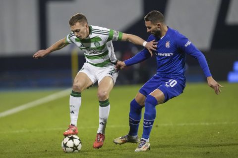 Celtic's Alistair Johnston, left, challenges for the ball with Dinamo's Marko Pjaca during the Champions League opening phase soccer match between Dinamo Zagreb and Celtic, at Maksimir stadium in Zagreb, Croatia, Tuesday, Dec. 10, 2024. (AP Photo/Darko Vojinovic)