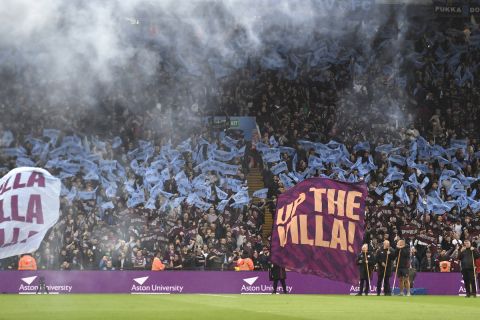 Aston Villa supporters burn flares ahead the English Premier League soccer match between Aston Villa and Liverpool at the Villa Park stadium in Birmingham, England, Monday, May 13, 2024. (AP Photo/Rui Vieira)