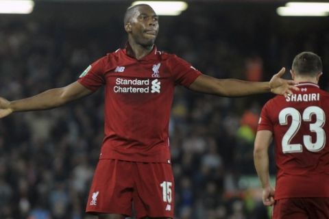 Liverpool's Daniel Sturridge, left, celebrates after scoring his side's opening goal during the English League Cup soccer match between Liverpool and Chelsea at Anfield stadium in Liverpool, England, Wednesday, Sept. 26, 2018. (AP Photo/Rui Vieira)