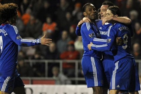 Chelsea's John Terry (2nd R) celebrates with teammates after scoring during their English Premier League soccer match against Blackpool, in Blackpool, northern England March 7, 2011.   REUTERS/Nigel Roddis (BRITAIN - Tags: SPORT SOCCER) NO ONLINE/INTERNET USAGE WITHOUT A LICENCE FROM THE FOOTBALL DATA CO LTD. FOR LICENCE ENQUIRIES PLEASE TELEPHONE ++44 (0) 207 864 9000