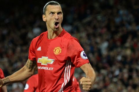 Manchester United's Swedish striker Zlatan Ibrahimovic celebrates after scoring their second goal from the penalty spot during the English Premier League football match between Manchester United and Southampton at Old Trafford in Manchester, north west England, on August 19, 2016. / AFP / Oli SCARFF / RESTRICTED TO EDITORIAL USE. No use with unauthorized audio, video, data, fixture lists, club/league logos or 'live' services. Online in-match use limited to 75 images, no video emulation. No use in betting, games or single club/league/player publications.  /         (Photo credit should read OLI SCARFF/AFP/Getty Images)