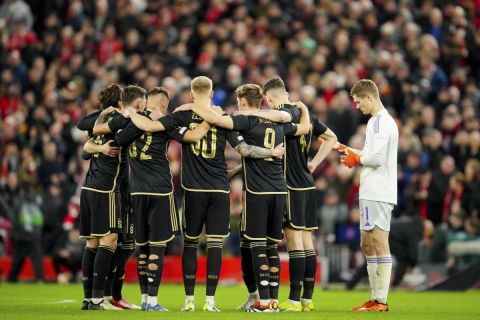 Sparta Praha players gather together on the pitch before the Europa League round of 16, second leg, soccer match between Liverpool and Sparta Praha at Anfield Stadium, Liverpool, England, Thursday March 14, 2024. (AP Photo/Jon Super)