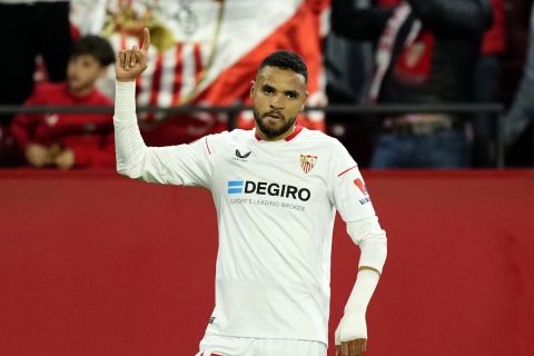 Sevilla's Youssef En-Nesyri celebrates after scoring his side's opening goal during the Europa League playoff first leg soccer match between Sevilla and PSV, at the Ramon Sanchez Pizjuan stadium in Seville, Spain, Thursday, Feb. 16, 2023. (AP Photo/Jose Breton)