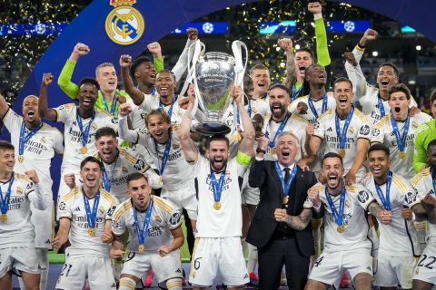 Real Madrid's players celebrate with the trophy after winning the Champions League final soccer match between Borussia Dortmund and Real Madrid at Wembley stadium in London, Saturday, June 1, 2024. (AP Photo/Kirsty Wigglesworth)