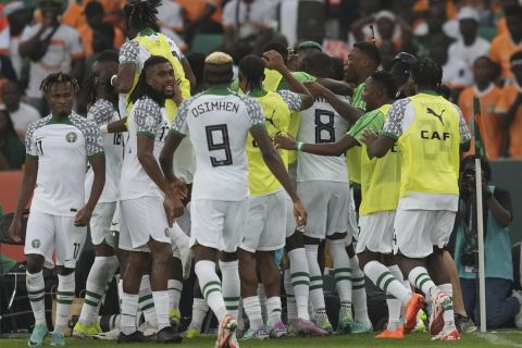 Nigeria players celebrate after William Troost-Ekong scored his side's opening goal during the African Cup of Nations Group A soccer match between Ivory Coast v Nigeria at the Olympic Stadium of Ebimpe, Abidjan, Ivory Coast, Thursday, Jan. 18, 2024. (AP Photo/Sunday Alamba)