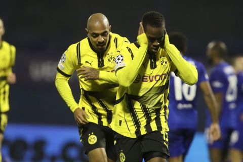 Dortmund's Jamie Bynoe-Gittens, right, celebrates after scoring his side's opening goal during the Champions League soccer match between Dinamo Zagreb and Dortmund at Maksimir Stadium, in Zagreb, Croatia, Wednesday, Nov. 27, 2024. (AP Photo)