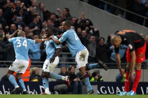 MANCHESTER, ENGLAND - MARCH 13:  Nigel De Jong of Manchester City (L) celebrates with goalscorer Micah Richards (C) and teammate Vincent Kompany (R) during the FA Cup sponsored by E.On Sixth Round match between Manchester City and Reading at the City of Manchester Stadium on March 13, 2011 in Manchester, England.  (Photo by Ian Walton/Getty Images)