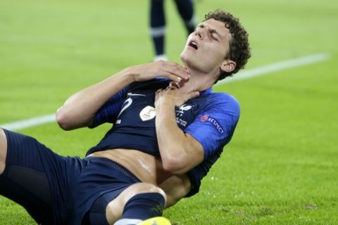 France's Benjamin Parvard reacts after making contact with Germany's Antonio Ruediger during the UEFA Nations League soccer match between Germany and France in Munich, Germany, Thursday, Sept. 6, 2018. (AP Photo/Michael Probst)