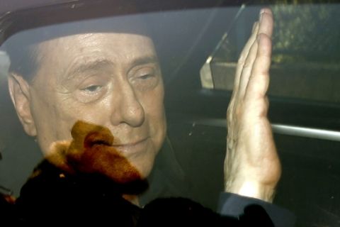 FILE -  in this Friday, July 18, 2014 file photo, Italy's former Premier Silvio Berlusconi waves as he leaves the 'Sacra Famiglia' institute in Cesano Boscone, Italy. Media mogul Silvio Berlusconi, who served three times as Italian premier, was undergoing heart surgery Tuesday June 14, 2016 at a Milan hospital. (AP Photo/Luca Bruno, File)