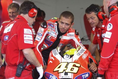 Ducati MotoGP rider Valentino Rossi of Italy checks his bike before the third free practice session at the Czech Grand Prix in Brno August 13, 2011.   REUTERS/Petr Josek (CZECH REPUBLIC - Tags: SPORT MOTOR RACING)