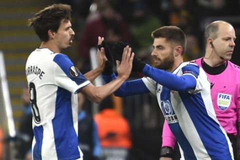 Espanyol's Ander Iturraspe, left, walks off after being substituted by Espanyol's David Lopez during the Europa League round of 32 match between Wolverhampton Wanderers and Espanyol at the Molineux Stadium, in Wolverhampton, England, Thursday, Feb. 20, 2020. (AP Photo/ Rui Vieira)