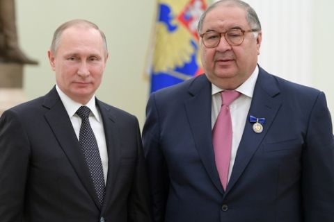 Russian President Vladimir Putin, left, poses for a photo with USM Holdings founder, businessman Alisher Usmanov during an awarding ceremony in Moscow's Kremlin, Russia, Thursday, Jan. 26, 2017 (Alexei Druzhinin/Sputnik, Kremlin Pool Photo via AP)