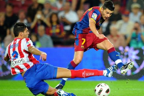 Barcelona's forward David Villa (R) vies with Sporting Gijon's defender Alberto Botia (L) during their Spanish League football match Barcelona against Sporting Gijon on September 22, 2010 at the Camp Nou stadium in Barcelona. AFP PHOTO/LLUIS GENE (Photo credit should read LLUIS GENE/AFP/Getty Images)