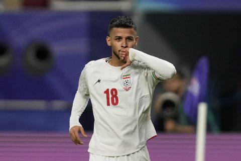 Iran's Mehdi Ghayedi celebrates after scoring the opening goal during the Asian Cup Group C soccer match between Hong Kong and Iran at Khalifa International Stadium in Doha, Qatar, Friday, Jan. 19, 2024. (AP Photo/Thanassis Stavrakis)