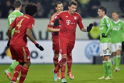 Bayern Munich's Spanish midfielder Javier Martinez (C) celebrates scoring with his teammates during the German first division Bundesliga football match VfL Wolfsburg vs FC Bayern Munich in Wolfsburg, northern Germany, on February 15, 2013.     AFP PHOTO / ODD ANDERSEN

RESTRICTIONS / EMBARGO - DFL RULES TO LIMIT THE ONLINE USAGE DURING MATCH TIME TO 15 PICTURES PER MATCH. IMAGE SEQUENCES TO SIMULATE VIDEO IS NOT ALLOWED AT ANY TIME. FOR FURTHER QUERIES PLEASE CONTACT DFL DIRECTLY AT + 49 69 650050.        (Photo credit should read ODD ANDERSEN/AFP/Getty Images)