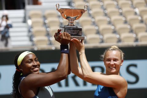 Coco Gauff of the U.S., left, and Katerina Siniakova of the Czech Republic pose with the trophy as they won the women's doubles final match of the French Open tennis tournament against Italy's Sara Errani and Jasmine Paolini at the Roland Garros stadium in Paris, Sunday, June 9, 2024. (AP Photo/Jean-Francois Badias)