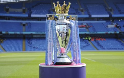 The Premier League trophy for Manchester City sits on the pitch prior to the English Premier League soccer match between Manchester City and Huddersfield Town at Etihad stadium in Manchester, England, Sunday, May 6, 2018. (AP Photo/Rui Vieira)