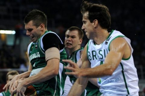 Raul Neto Togni of Brazil (L) viess for the ball with Sani Beciravic (R) of Slovenia during the Group B preliminary round match between the Brasil and Slovenia on September 1, 2010 in Istanbul. The FIBA World Basketball Championship match will be played in the Abdi Ipekci Arena. AFP PHOTO / BULENT KILIC (Photo credit should read BULENT KILIC/AFP/Getty Images)