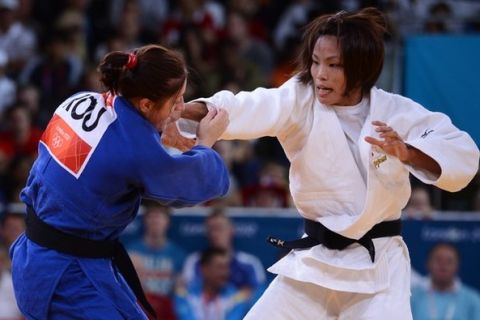 Japan's Kaori Matsumoto (white) competes with Romania's Corina Caprioriu (blue) during their women's -57kg judo contest final match of the London 2012 Olympic Games on July 30, 2012 ExCel arena in London.   AFP PHOTO / FRANCK FIFE        (Photo credit should read FRANCK FIFE/AFP/GettyImages)