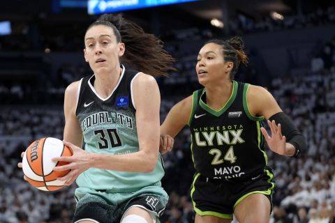 New York Liberty forward Breanna Stewart (30) drives past Minnesota Lynx forward Napheesa Collier (24) during the first half in Game 3 of a WNBA basketball final playoff series, Wednesday, Oct. 16, 2024, in Minneapolis. (AP Photo/Abbie Parr)