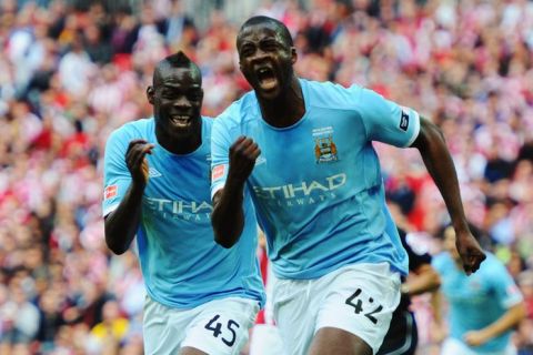 LONDON, ENGLAND - MAY 14:  Yaya Toure (R) of Manchester City celebrates with Mario Balotelli (L) after scoring during the FA Cup sponsored by E.ON Final match between Manchester City and Stoke City at Wembley Stadium on May 14, 2011 in London, England.  (Photo by Mike Hewitt/Getty Images)