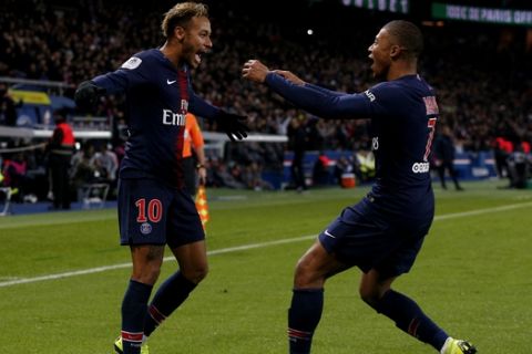 PSG's Kylian Mbappe, right, runs towards PSG's Neymar, celebrating after he scored his side second goal during the League One soccer match between Paris Saint-Germain and Lille at the Parc des Princes stadium in Paris, Friday, Nov. 2, 2018. (AP Photo/Thibault Camus)