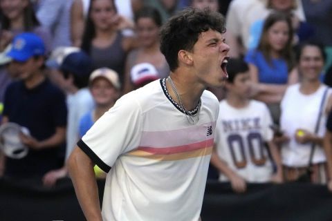 Ben Shelton of the U.S. celebrates after defeating compatriot J.J. Wolf in their fourth round match at the Australian Open tennis championship in Melbourne, Australia, Monday, Jan. 23, 2023. (AP Photo/Ng Han Guan)