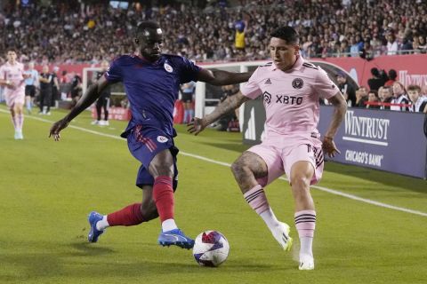 Chicago Fire midfielder Ousmane Doumbia, left, and Inter Miami midfielder Facundo Farías vie for the ball during the first half of an MLS soccer match in Chicago, Wednesday, Oct. 4, 2023. (AP Photo/Nam Y. Huh)