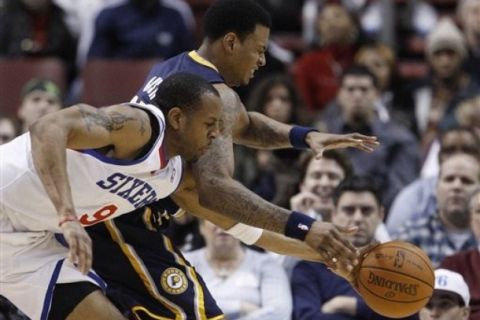 Philadelphia 76ers' Andre Iguodala, left, steals the ball from Indiana Pacers' Brandon Rush in the second half of an NBA basketball game Tuesday, Jan. 11, 2011, in Philadelphia. Indiana won 111-103. (AP Photo/Matt Slocum)