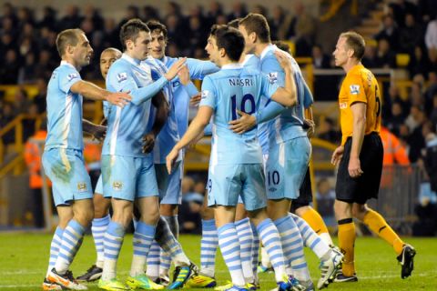 Manchester City's Edin Dzeko (L) celebrates scoring with his team-mates during their League Cup fourth round football match against Wolverhampton Wanders at Molineux Stadium, Wolverhampton, on October 26, 2011. AFP PHOTO/Olly Greenwood

FOR EDITORIAL USE ONLY Additional license required for any commercial/ promotional use or use on TV or internet (except identical online version of newspaper) of Premier League/Football photos. Tel DataCo  
+44 207 2981656. Do not alter/modify photo. (Photo credit should read OLLY GREENWOOD/AFP/Getty Images)